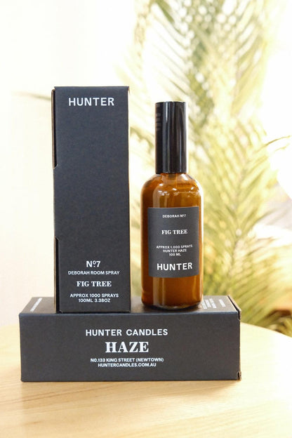 Hunter Candles Fig Tree room spray bottle on box with palm leaves in background