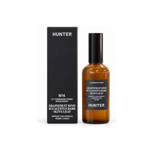 Hunter Candles Haze Tasmanian Creek room spray bottle standing beside tall matte black box