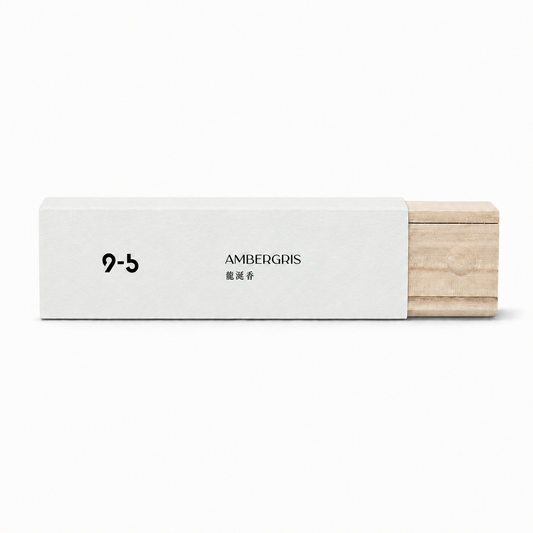 Ambergris incense sticks in white textured paper sleeve and light wood box with moon detail