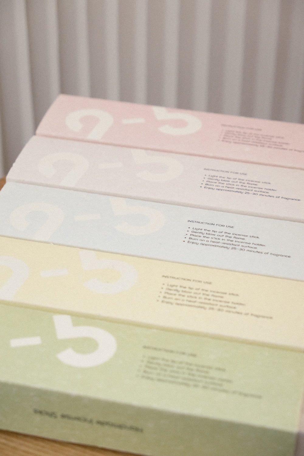 Close-up of incense packaging sleeve showing usage instructions and 9-5 logo