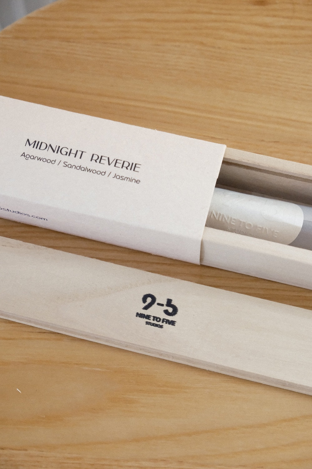 Midnight Reverie incense sticks packaging detail showing white textured sleeve and natural wood box with agarwood sandalwood jasmine notes