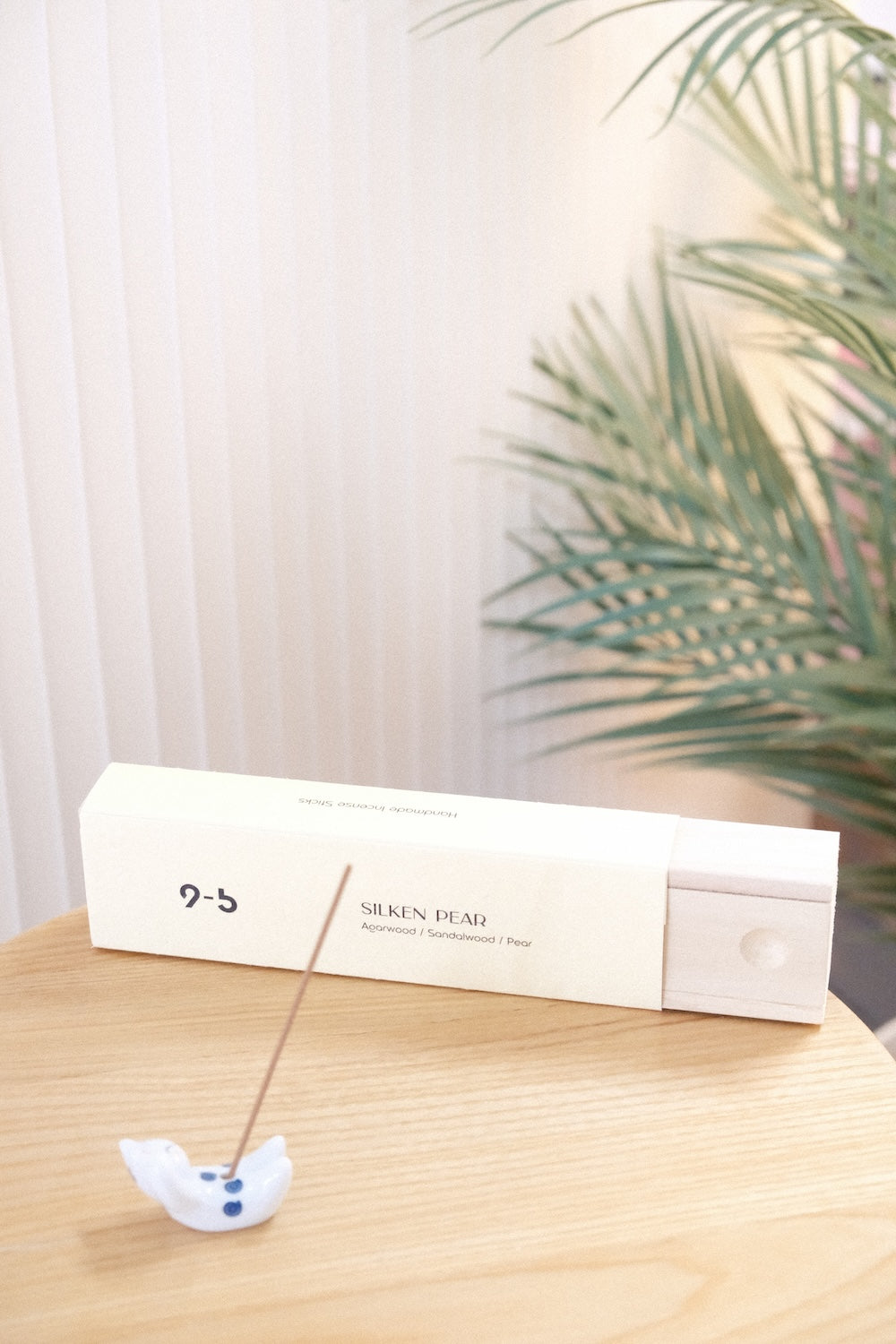 Silken Pear incense box with lit stick in ceramic holder