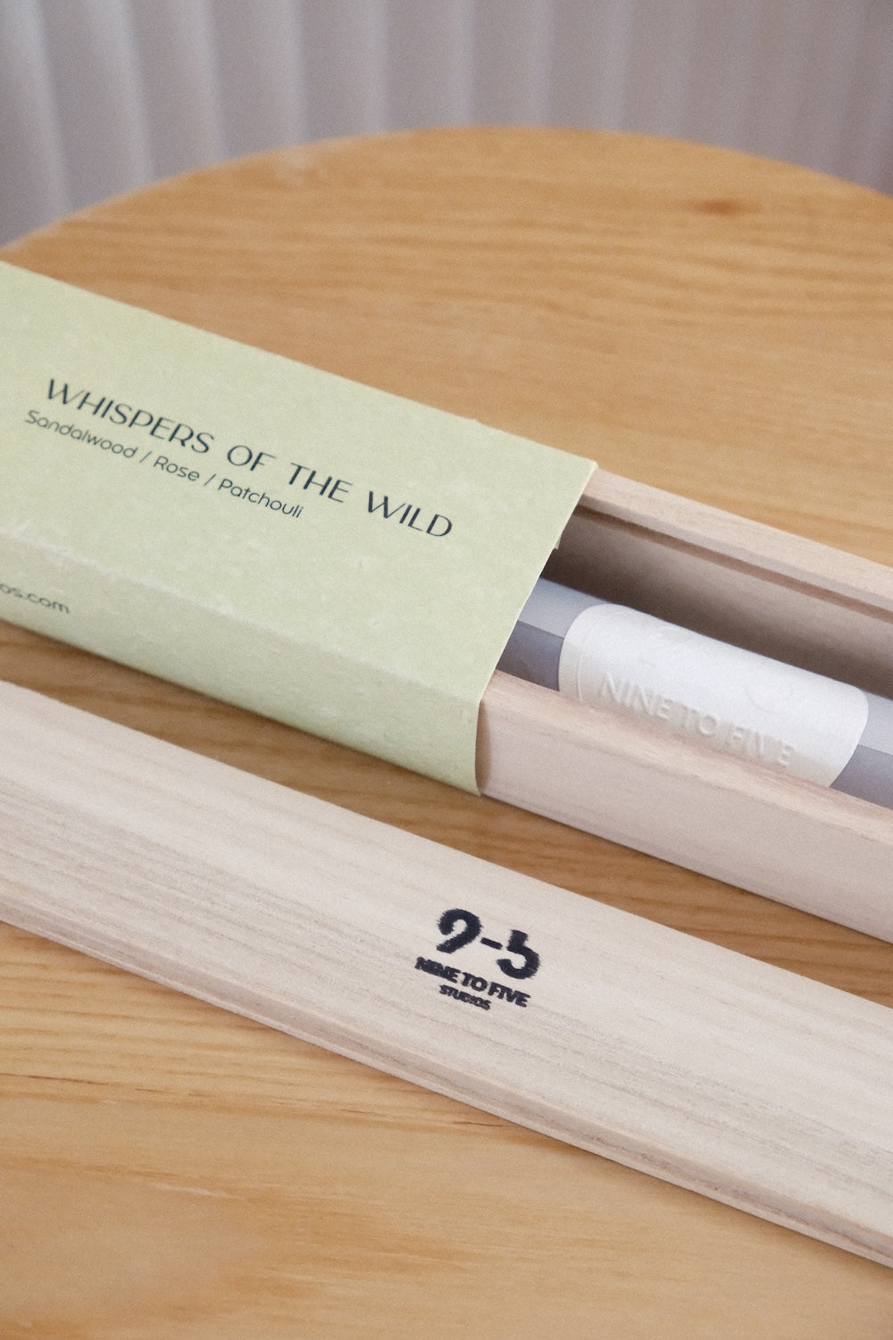 Pale sage green incense box slid open revealing inner tube and stamped wooden tray logo