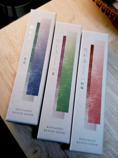 Three Kousaido incense boxes with layered color gradients on wood by 9to5 Studios