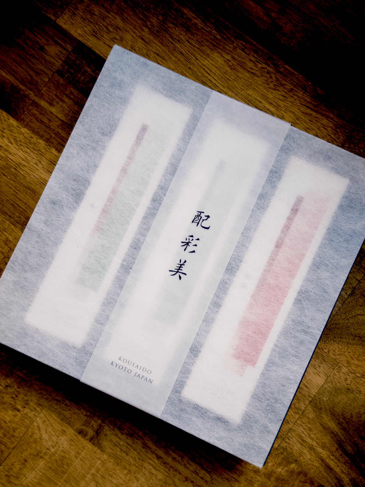 Top-down view of light blue fibrous Kousaido incense gift box with Japanese text at 9to5 Studios