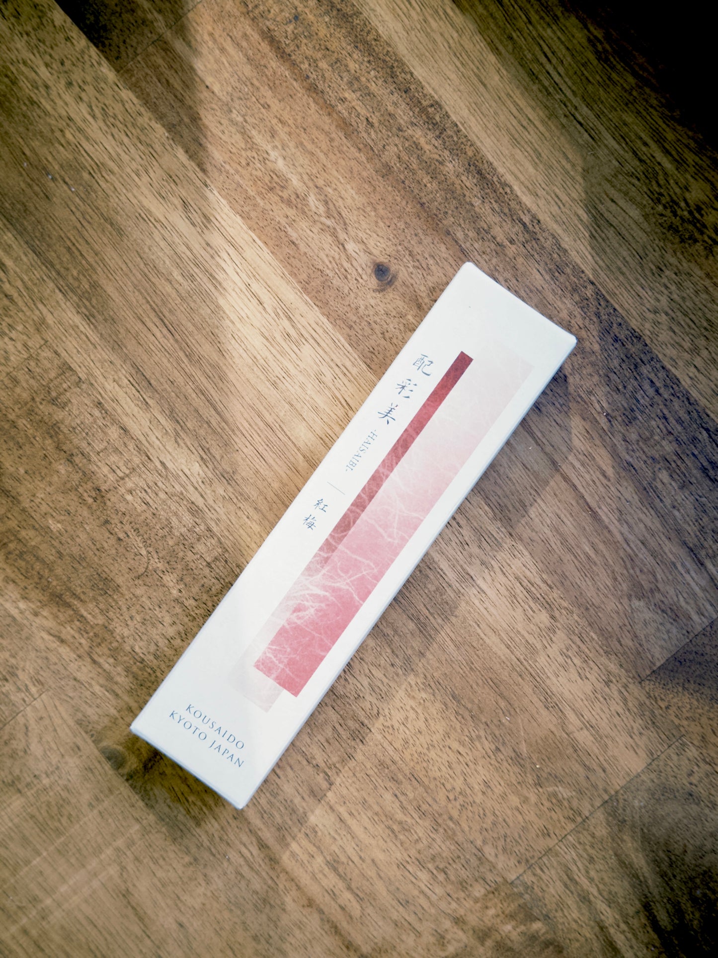 Kousaido Red Plum Blossoms incense sticks box on wood floor at 9to5 Studios