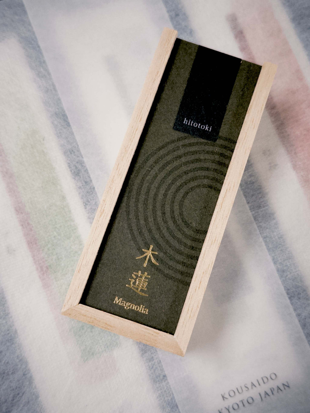 Kousaido Hitotoki Magnolia Incense Sticks packaging with olive green textured paper and gold kanji at 9to5 Studios