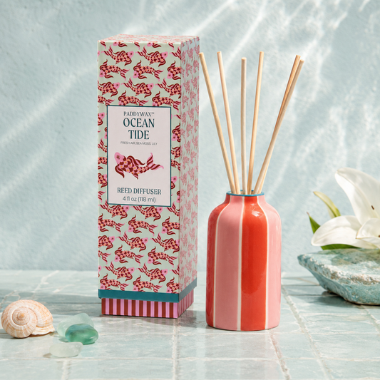 9to5 Studios Paddywax Ocean Tide Reed Diffuser styled on blue mosaic tiles with seashell and sea glass for coastal home decor
