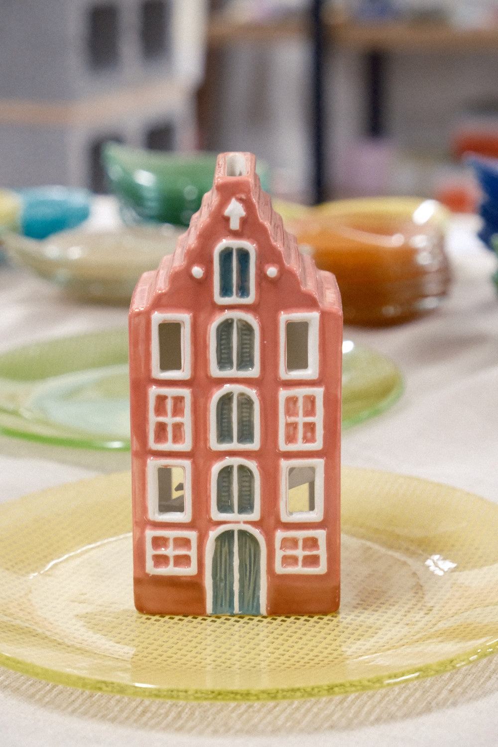 Paddywax Amsterdam House ceramic incense and tea light holder inspired by Dutch canal houses releasing smoke through chimney.