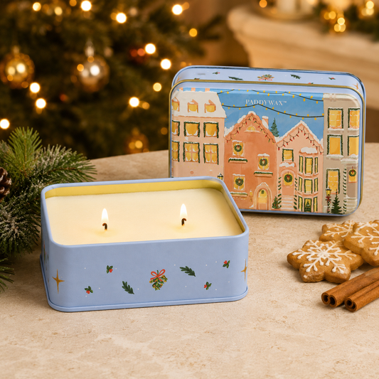 9to5 Studios Paddywax Gingerbread Holiday Tin Candle with two lit wicks, holly and gold star details on matte tin