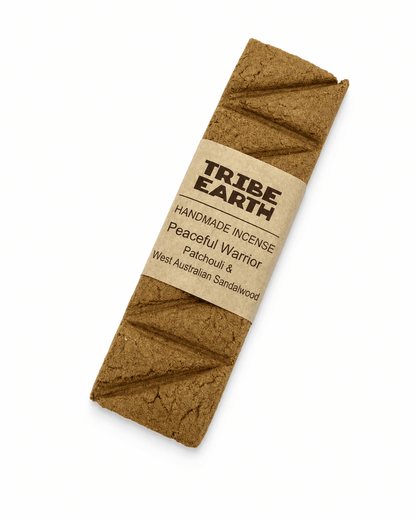 Tribe Earth Peaceful Warrior handmade incense plank with sandalwood and patchouli burning in a heat resistant dish