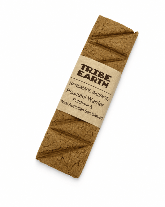 Tribe Earth Peaceful Warrior handmade incense plank with sandalwood and patchouli burning in a heat resistant dish