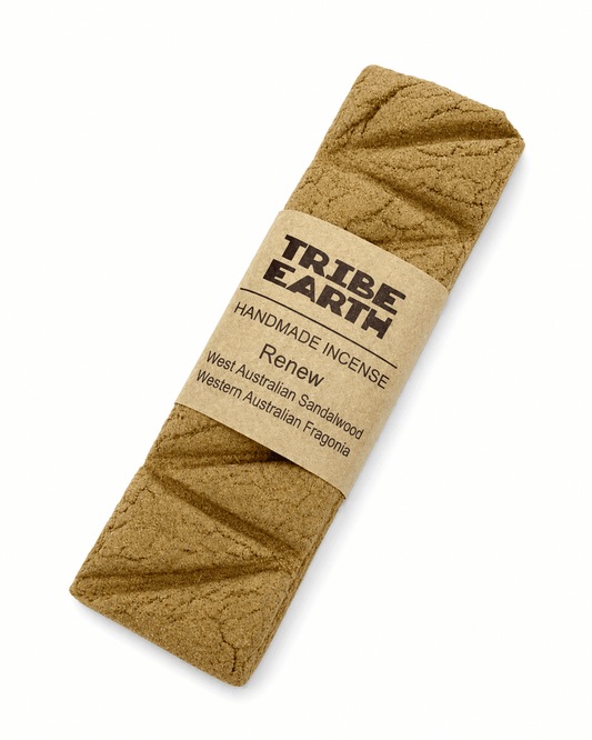 Tribe Earth RENEW Handmade Incense Plank with Sandalwood and Fragonia burning in a heat-resistant dish