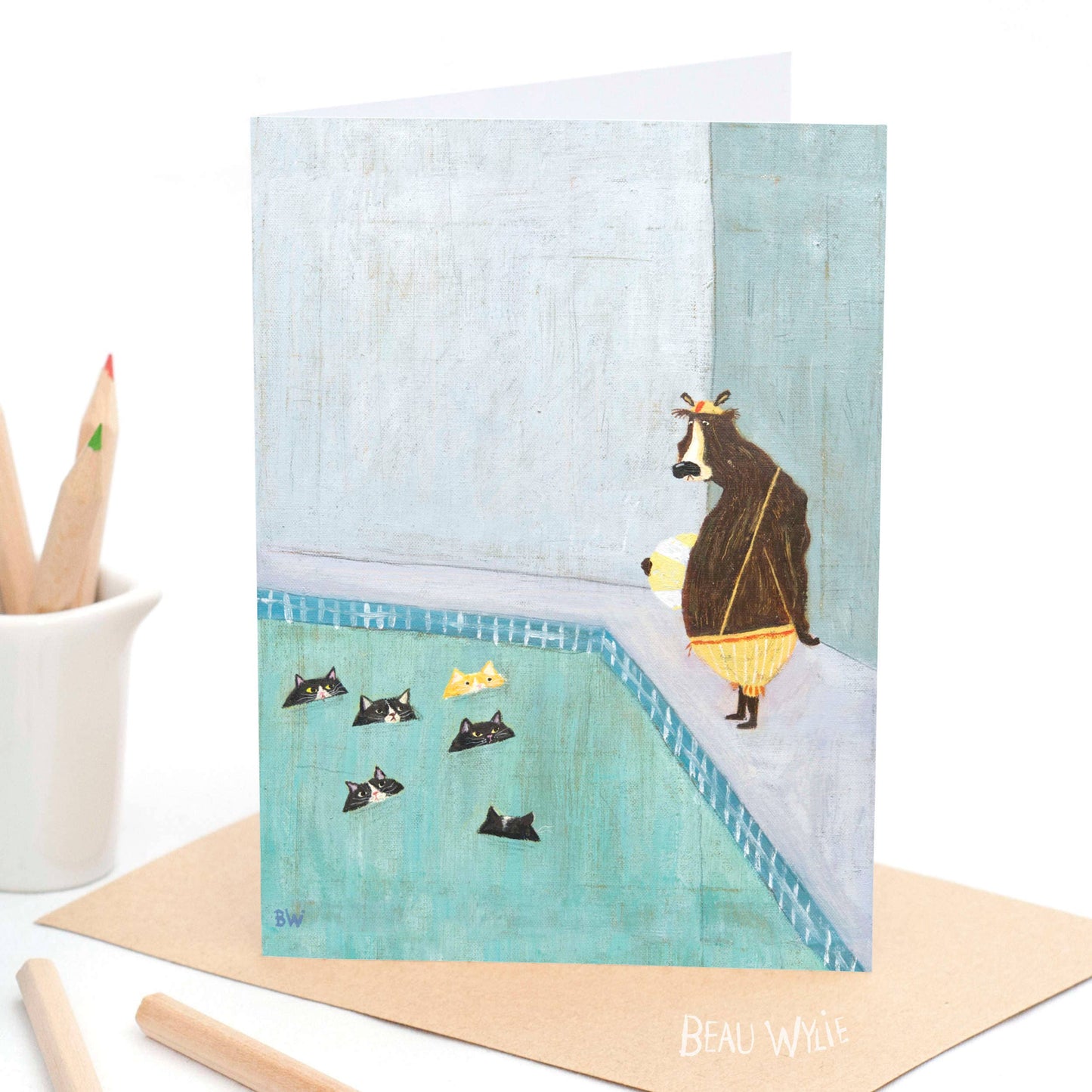 Recreation Hour greeting card by Beau Wylie for 9to5 Studios featuring a bear in swimsuit watching cats in a pool on textured white recycled cardstock