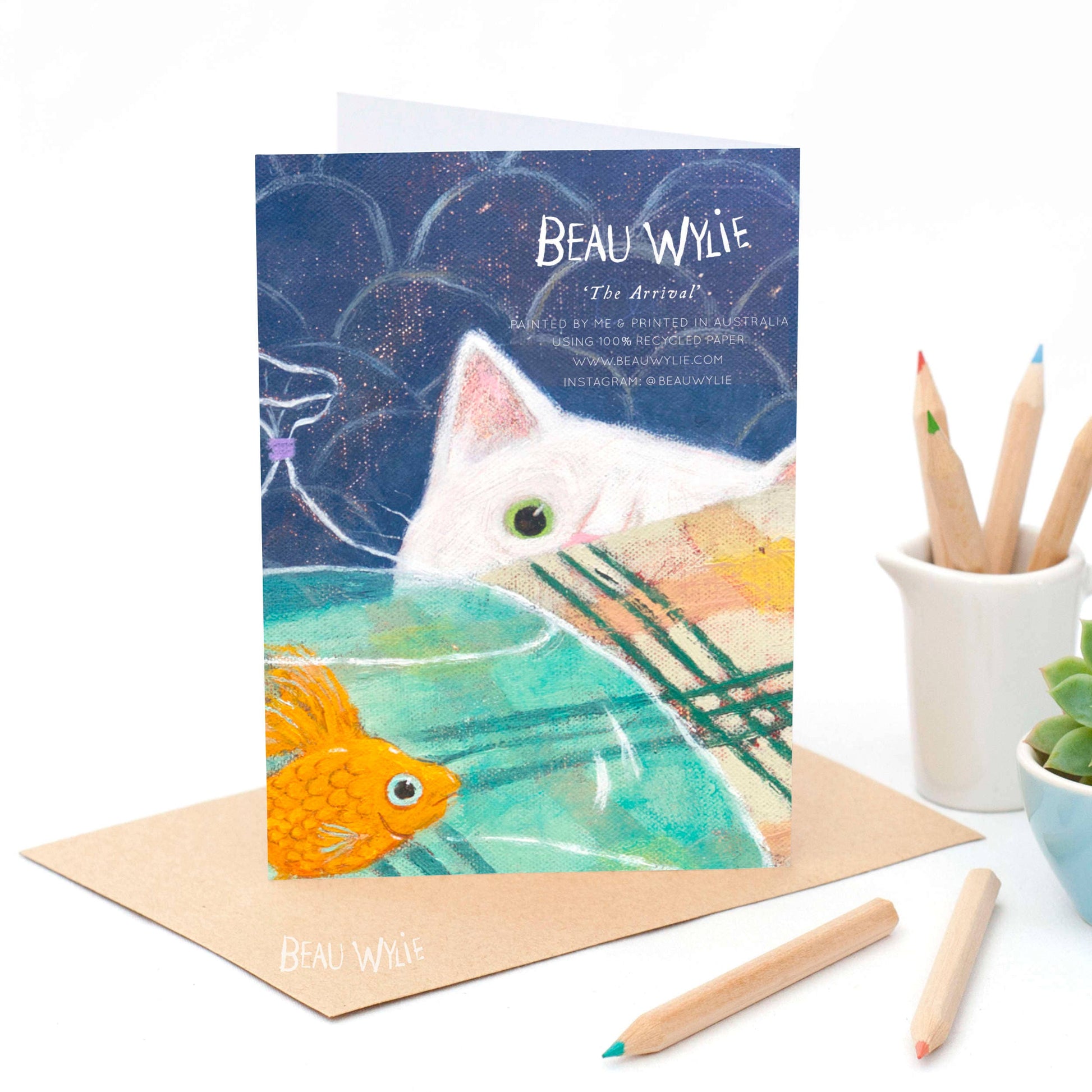 Back of The Arrival A6 greeting card by Beau Wylie printed in Australia on recycled paper showing cat details and eco-friendly text
