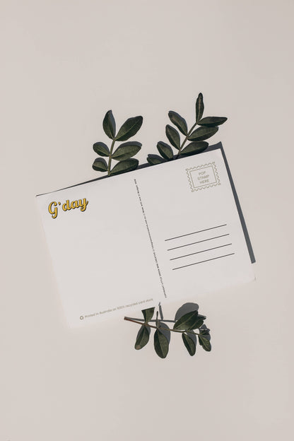 Back of 9to5 Studios Australia postcard displaying G'day gold script, stamp box, and address lines on white recycled stock