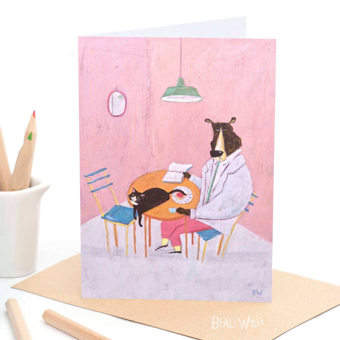 Beau Wylie Toast greeting card from 9to5 Studios showing bear in pink pants and yellow socks with cat at table, hand-painted texture