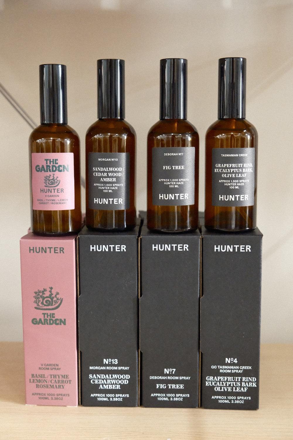Hunter Candles amber glass room spray bottles with black caps and botanical scent labels in varied colours